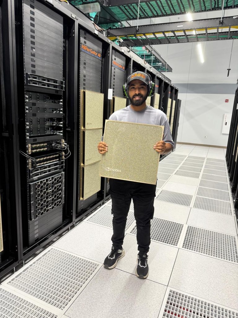 Anany Sharma holding a golden NVIDIA plate at the data center facilities inside the HiPerGator supercomputer at the University of Florida.